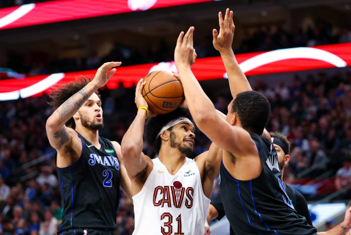 Dec 23, 2023; Dallas, Texas, USA; Cleveland Cavaliers center Jarrett Allen (31) looks to shoot as Dallas Mavericks center Dereck Lively II (2) and Dallas Mavericks forward Grant Williams (3) defend during the second quarter at American Airlines Center. Mandatory Credit: Kevin Jairaj-USA TODAY Sports